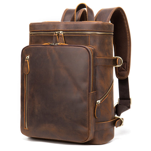 A vintage brown Crazy Horse leather backpack with multiple compartments, secure zippers, and adjustable shoulder straps.